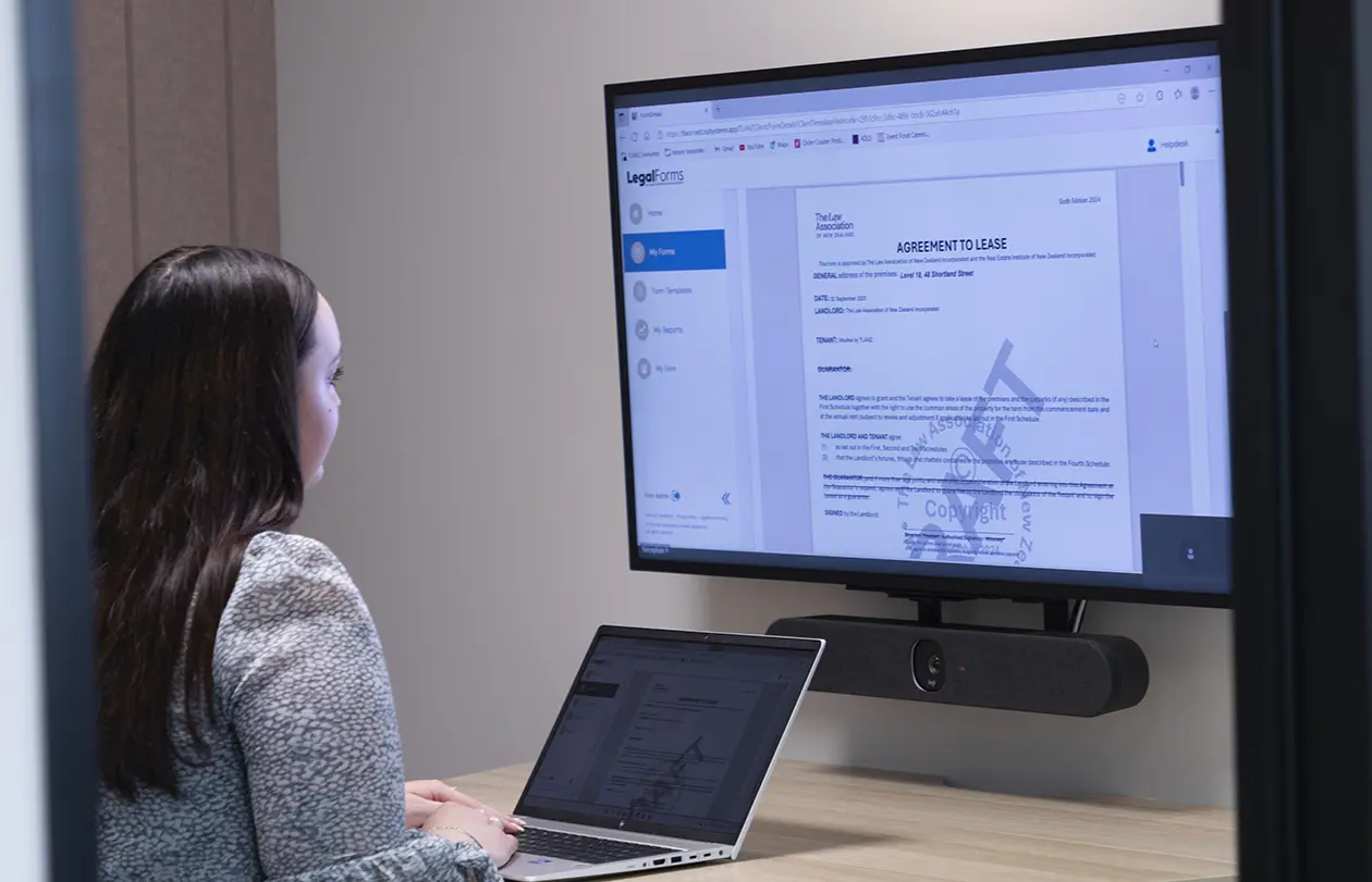 Woman looking at Legal Forms on large monitor
